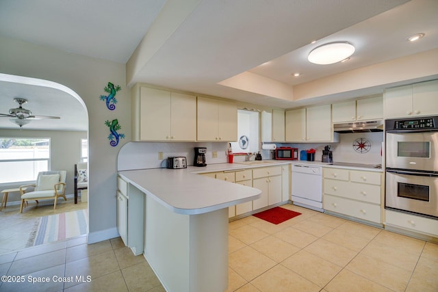 kitchen with ceiling fan, dishwasher, sink, double oven, and kitchen peninsula