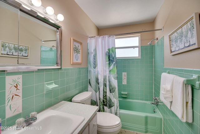 full bathroom with vanity, shower / tub combo, tile walls, and toilet