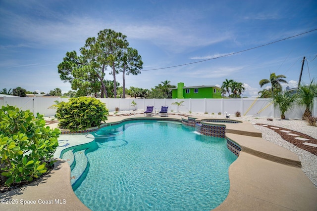 view of swimming pool with an in ground hot tub