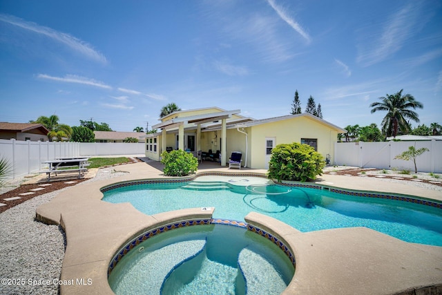 view of pool with an in ground hot tub and a patio