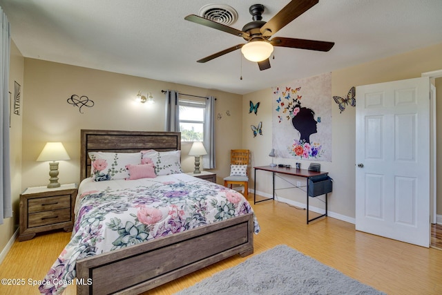 bedroom with ceiling fan and light hardwood / wood-style flooring