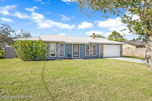 ranch-style home with a garage and a front lawn