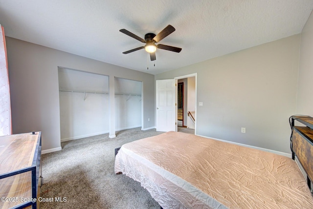 carpeted bedroom with ceiling fan and a textured ceiling