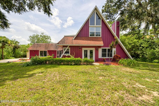 view of front of house with a front yard and french doors