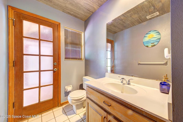 bathroom featuring tile patterned flooring, vanity, toilet, and plenty of natural light