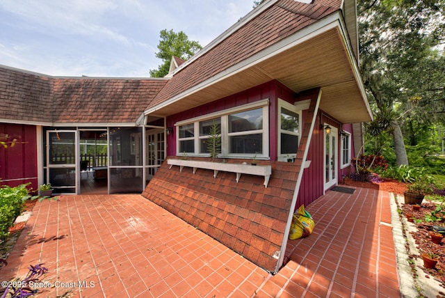 view of patio featuring a sunroom