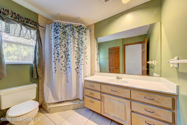 bathroom featuring tile patterned floors, walk in shower, vanity, and toilet