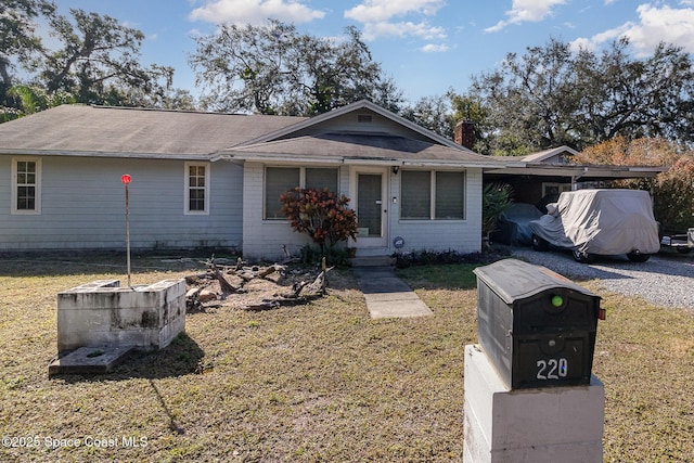 ranch-style home with a front lawn