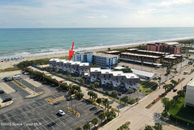 aerial view featuring a view of the beach and a water view