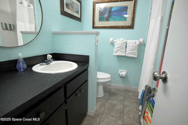 bathroom with tile patterned flooring, vanity, and toilet