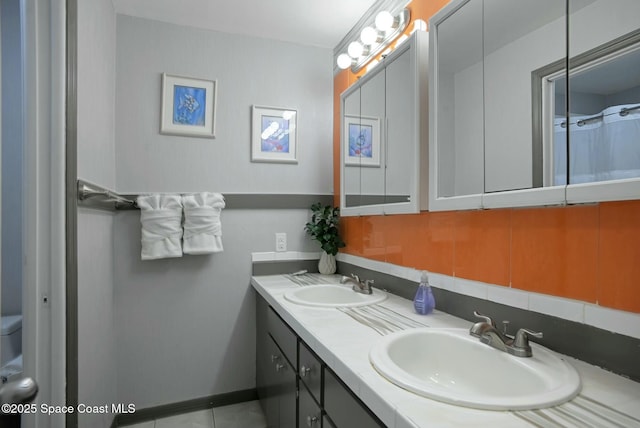 bathroom with vanity and tasteful backsplash