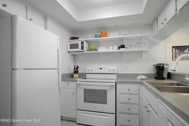 kitchen with white cabinets, white appliances, and sink