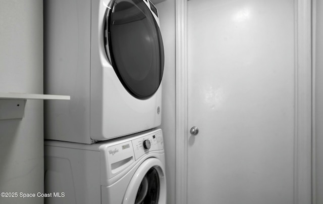 laundry room featuring stacked washer and clothes dryer