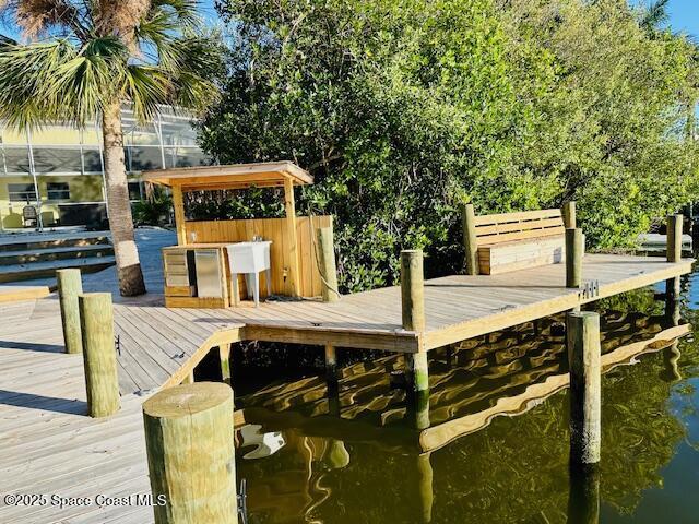 dock area with a water view and glass enclosure