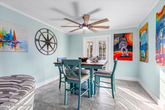 tiled dining space featuring ornamental molding, french doors, and ceiling fan