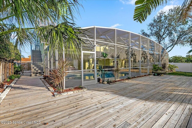 deck with a fenced in pool and glass enclosure