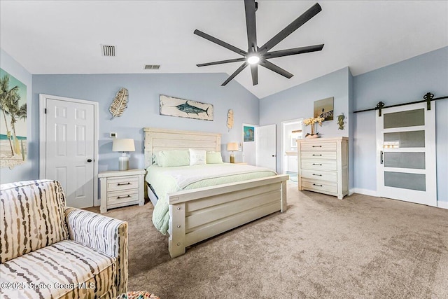 carpeted bedroom with vaulted ceiling, a barn door, and ceiling fan