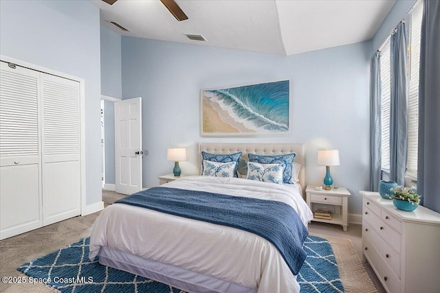 bedroom with vaulted ceiling, carpet floors, ceiling fan, and a closet