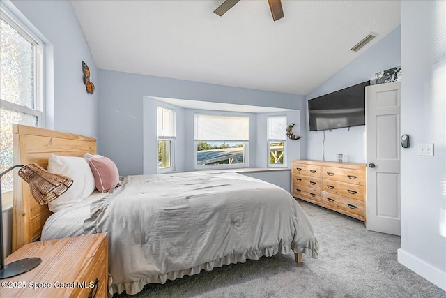 bedroom featuring ceiling fan, light colored carpet, and lofted ceiling