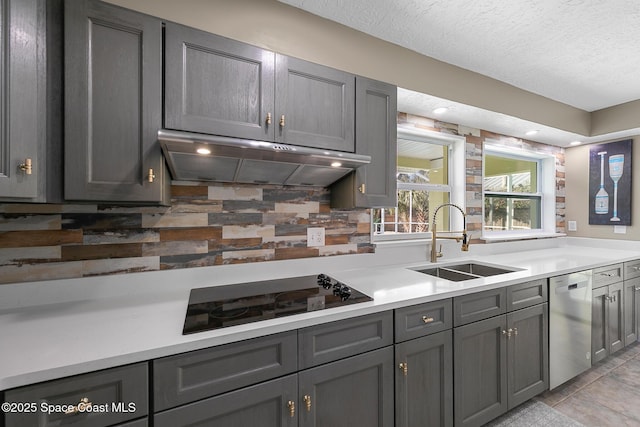 kitchen with tasteful backsplash, sink, gray cabinetry, stainless steel dishwasher, and black electric cooktop