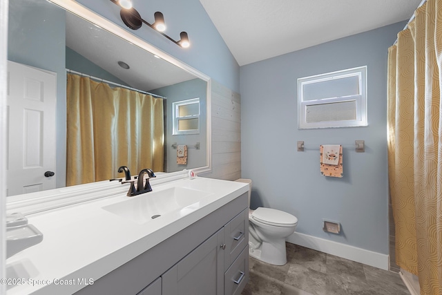 bathroom featuring lofted ceiling, vanity, and toilet