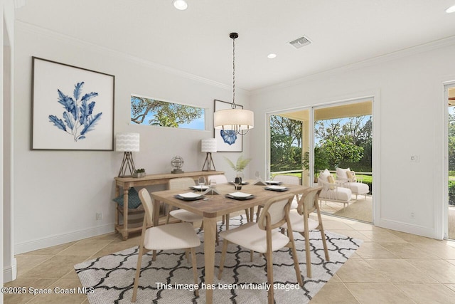 dining space featuring light tile patterned floors and crown molding