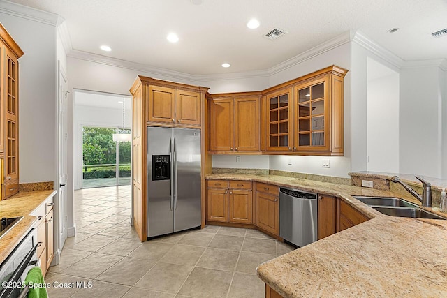 kitchen featuring visible vents, brown cabinets, appliances with stainless steel finishes, and a sink