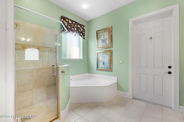 full bath featuring baseboards, a garden tub, a shower stall, and tile patterned flooring