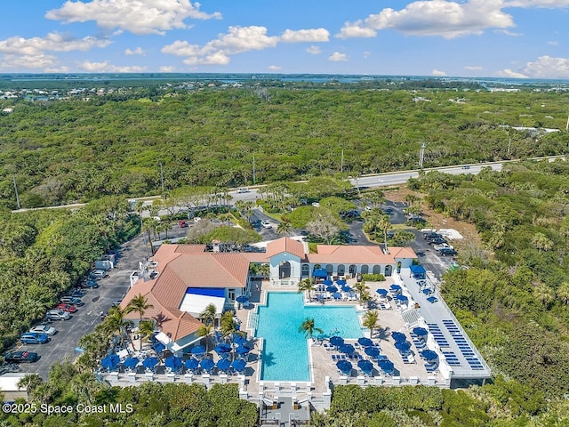 drone / aerial view featuring a forest view