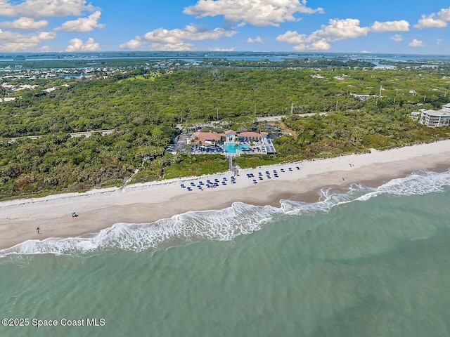 drone / aerial view featuring a water view and a beach view