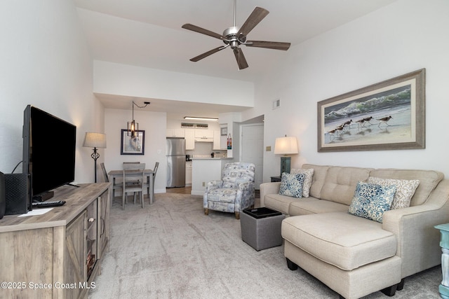 carpeted living room featuring ceiling fan