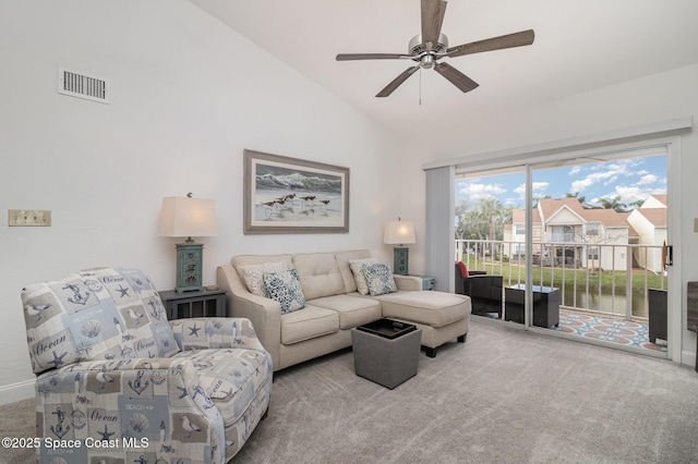 carpeted living room with a water view, ceiling fan, and lofted ceiling