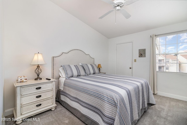 bedroom featuring light colored carpet, vaulted ceiling, and ceiling fan