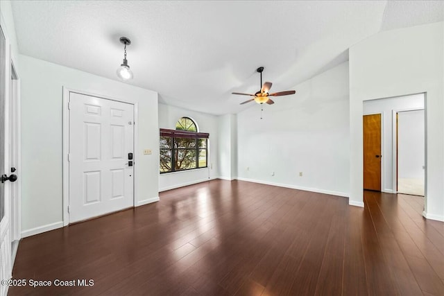 entryway featuring dark wood-type flooring, ceiling fan, and lofted ceiling