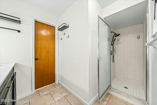 bathroom featuring tile patterned flooring, vanity, and walk in shower