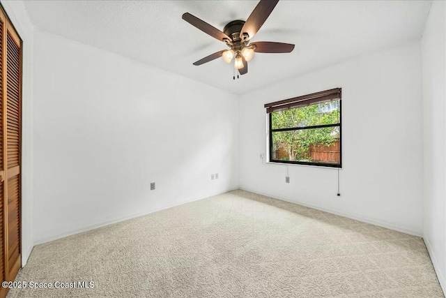 carpeted empty room with ceiling fan