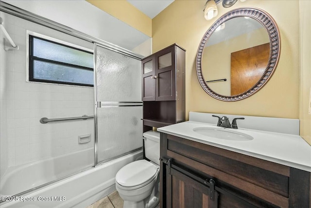 full bathroom featuring tile patterned flooring, vanity, toilet, and enclosed tub / shower combo