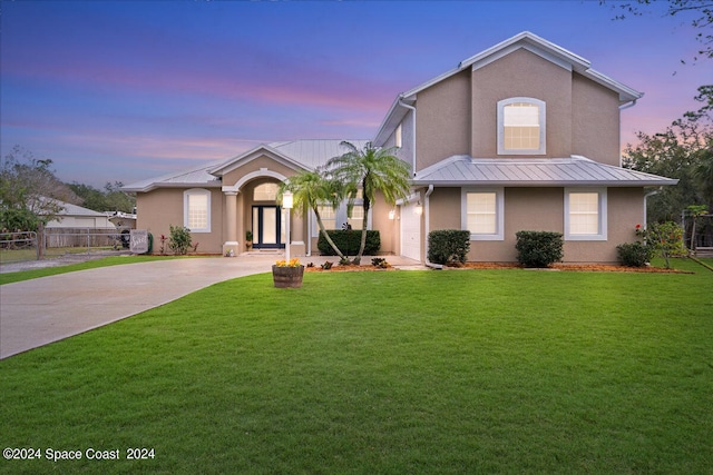 view of front of property with a lawn