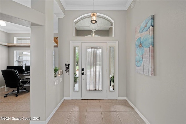 tiled foyer entrance featuring crown molding