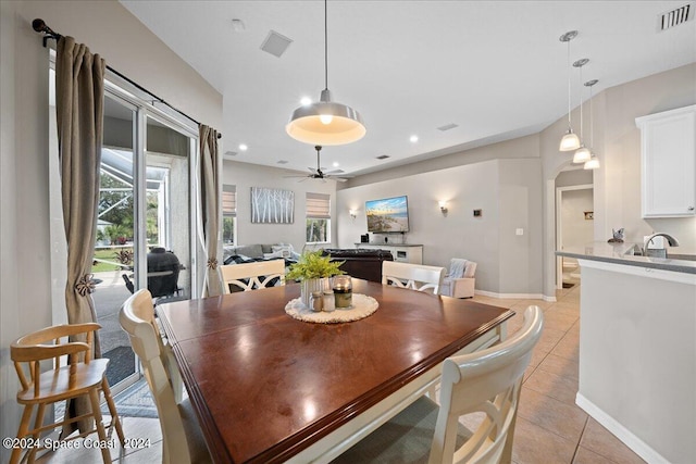 dining room with light tile patterned floors and ceiling fan