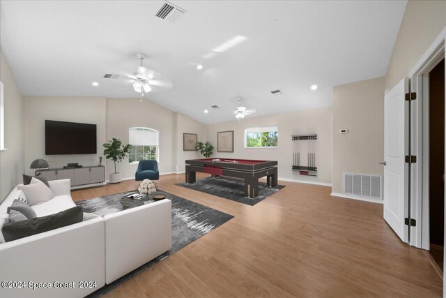 living room with a wealth of natural light, wood-type flooring, vaulted ceiling, and billiards