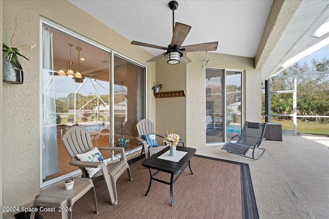 view of patio featuring glass enclosure and ceiling fan