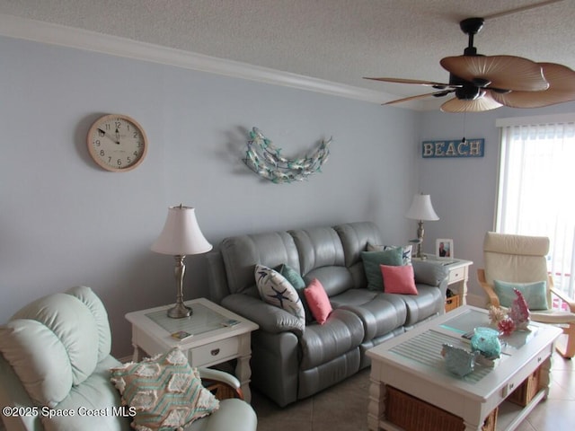 tiled living room with a textured ceiling, ceiling fan, and crown molding