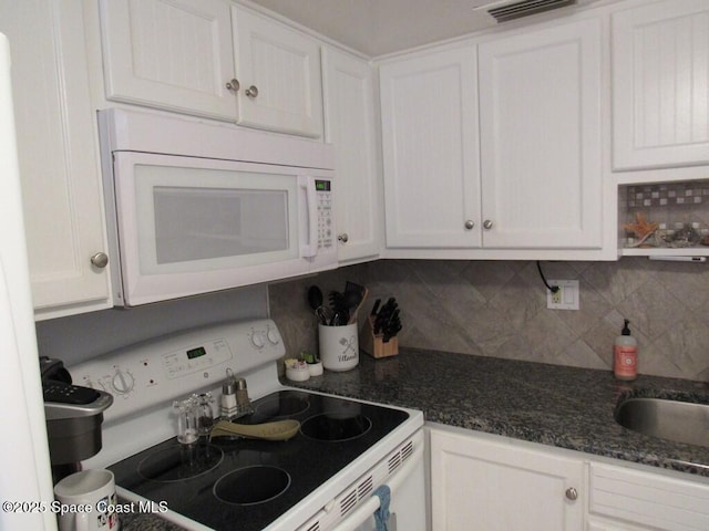 kitchen with white cabinets, white appliances, and backsplash