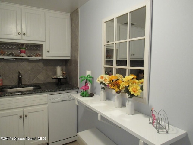 kitchen featuring tasteful backsplash, white cabinets, sink, and white dishwasher