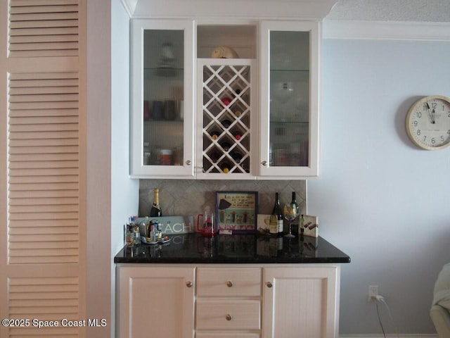 bar featuring white cabinets and tasteful backsplash