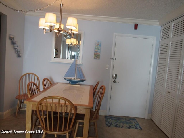 dining room featuring a textured ceiling, a notable chandelier, crown molding, and tile patterned floors