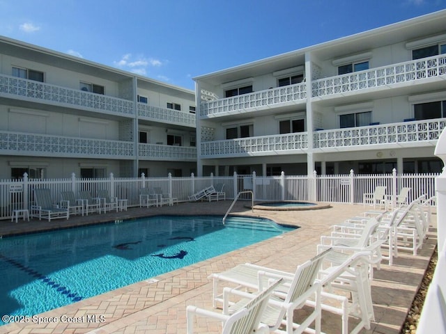 view of swimming pool featuring a community hot tub