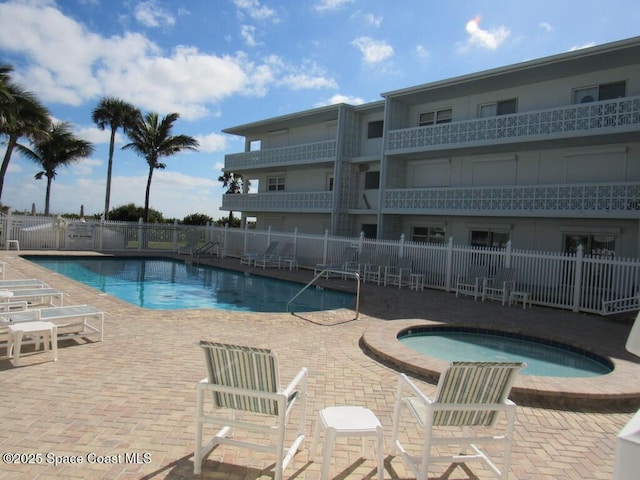 view of pool featuring a patio area and a community hot tub