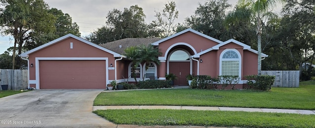 single story home with a front yard and a garage